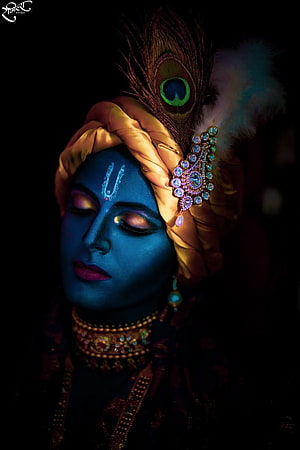 Krishna Portrait with Blue Face, Peacock Feather Crown, and Ornate Jewelry in Dramatic Low-Key Lighting HD phone wallpaper
