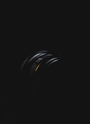 Minimalist Camera Lens Detail in Low Light with Dramatic Rim Lighting HD phone wallpaper
