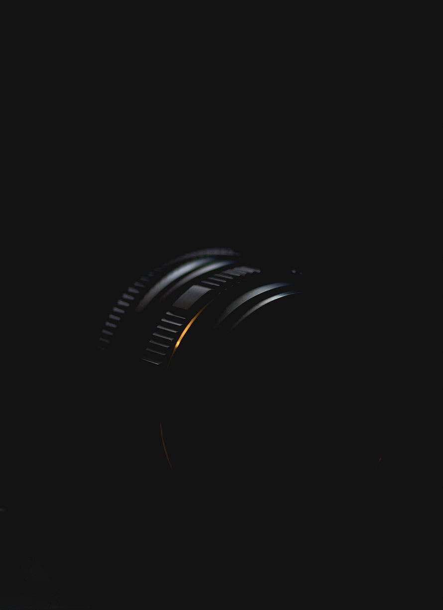 Minimalist Camera Lens Detail in Low Light with Dramatic Rim Lighting HD phone wallpaper