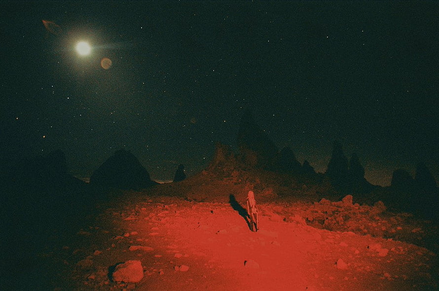Lone Figure Standing on Red Alien Terrain Under Starry Night Sky HD wallpaper