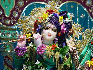 Ornate Radha Krishna Murti with Flute and Floral Garland in Temple Setting HD wallpaper