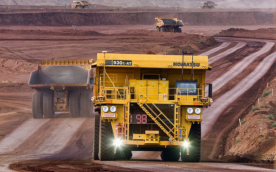 Komatsu 930E-AT Ultra-Class Mining Haul Truck Operating in Open Pit Iron Ore Quarry HD wallpaper
