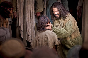 Jesus Healing a Sick Man in a Crowded Biblical Scene HD wallpaper