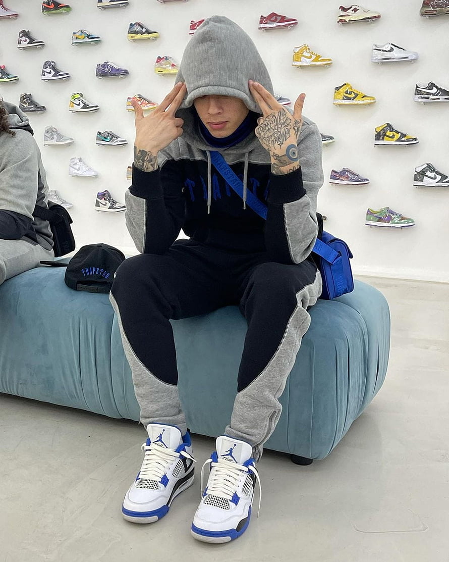 Central Cee in Trapstar Hoodie and Jordan 4 Sneakers at Sneaker Wall Display HD phone wallpaper