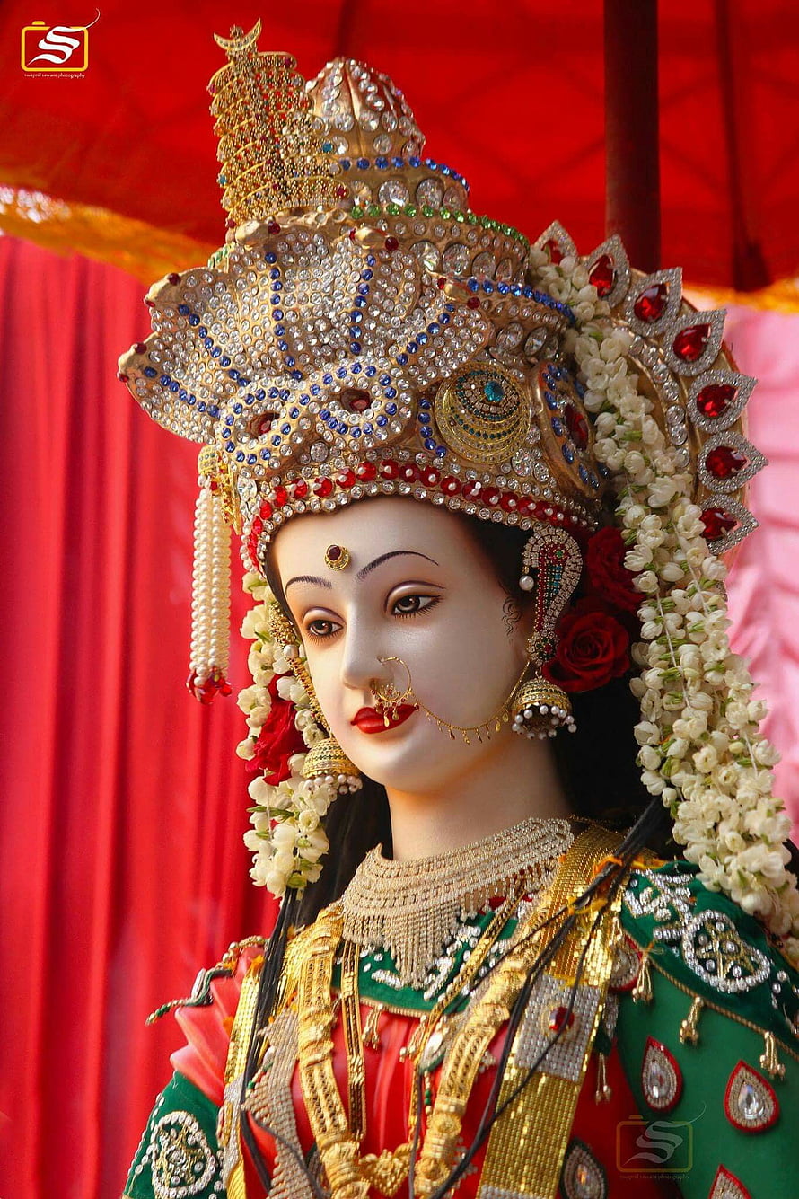 Ornate Navratri Mata Rani Deity Statue with Traditional Gold Crown and Floral Garland HD phone wallpaper