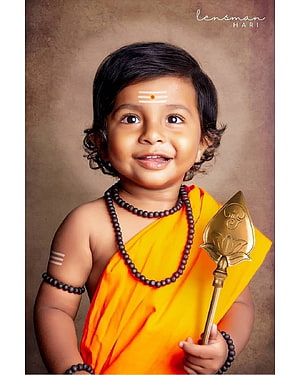 Baby Murugan Portrait in Orange Dhoti Holding Golden Vel with Rudraksha Beads HD phone wallpaper