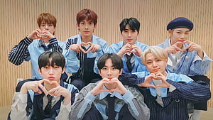 Enhypen Members Posing With Heart Hand Gestures In Coordinated Blue Outfits HD wallpaper