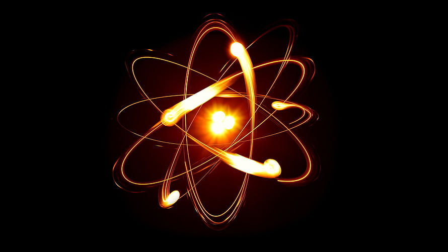 Glowing Atomic Structure with Orbiting Electrons and Radiant Core on Black Background HD wallpaper