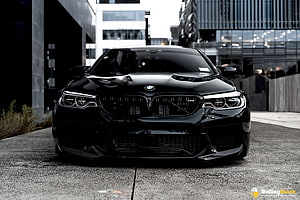 Black BMW M5 F90 Front Facade in Urban Setting HD wallpaper