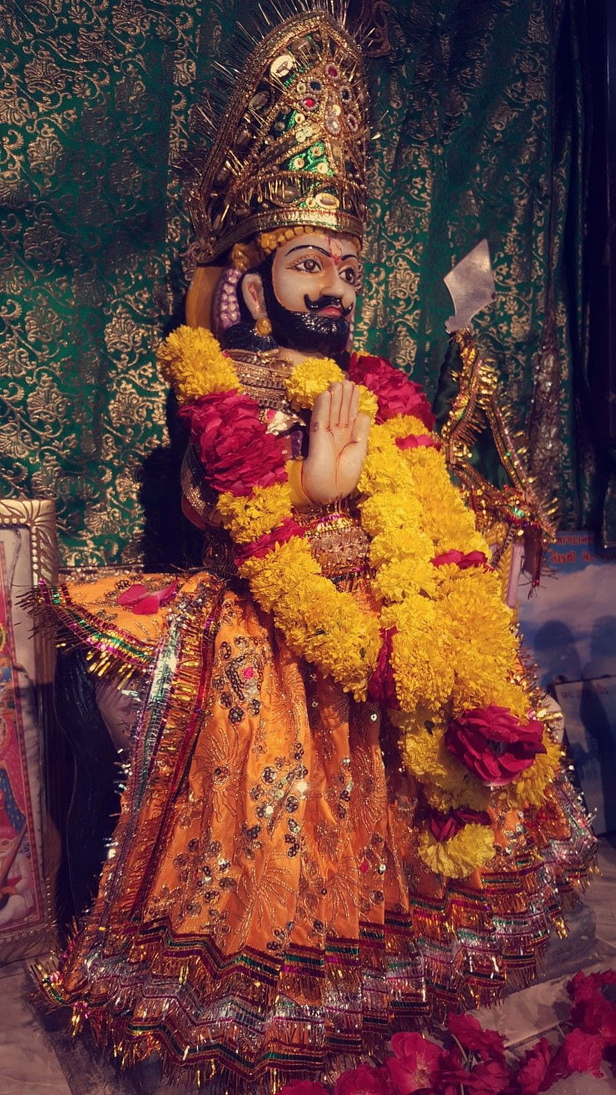Ornate Hindu Deity Statue Adorned With Marigold Garlands And Traditional Attire HD phone wallpaper