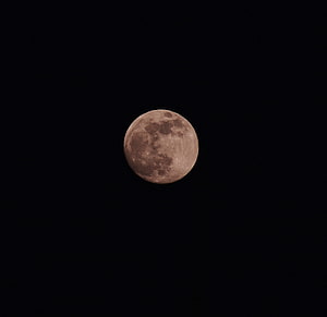 Full Moon Illuminated Against a Deep Black Night Sky HD wallpaper