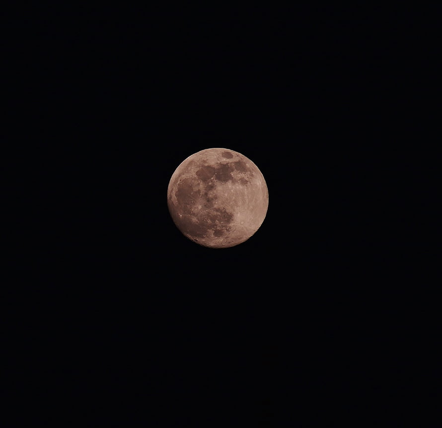 Full Moon Illuminated Against a Deep Black Night Sky HD wallpaper