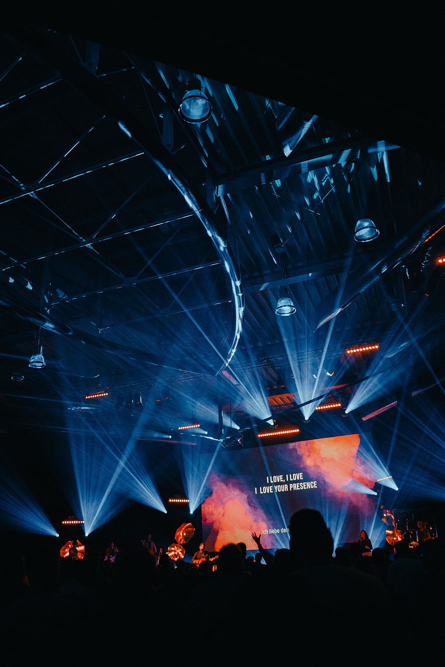 Vibrant Concert Stage With Blue Laser Beams And Silhouetted Crowd HD phone wallpaper