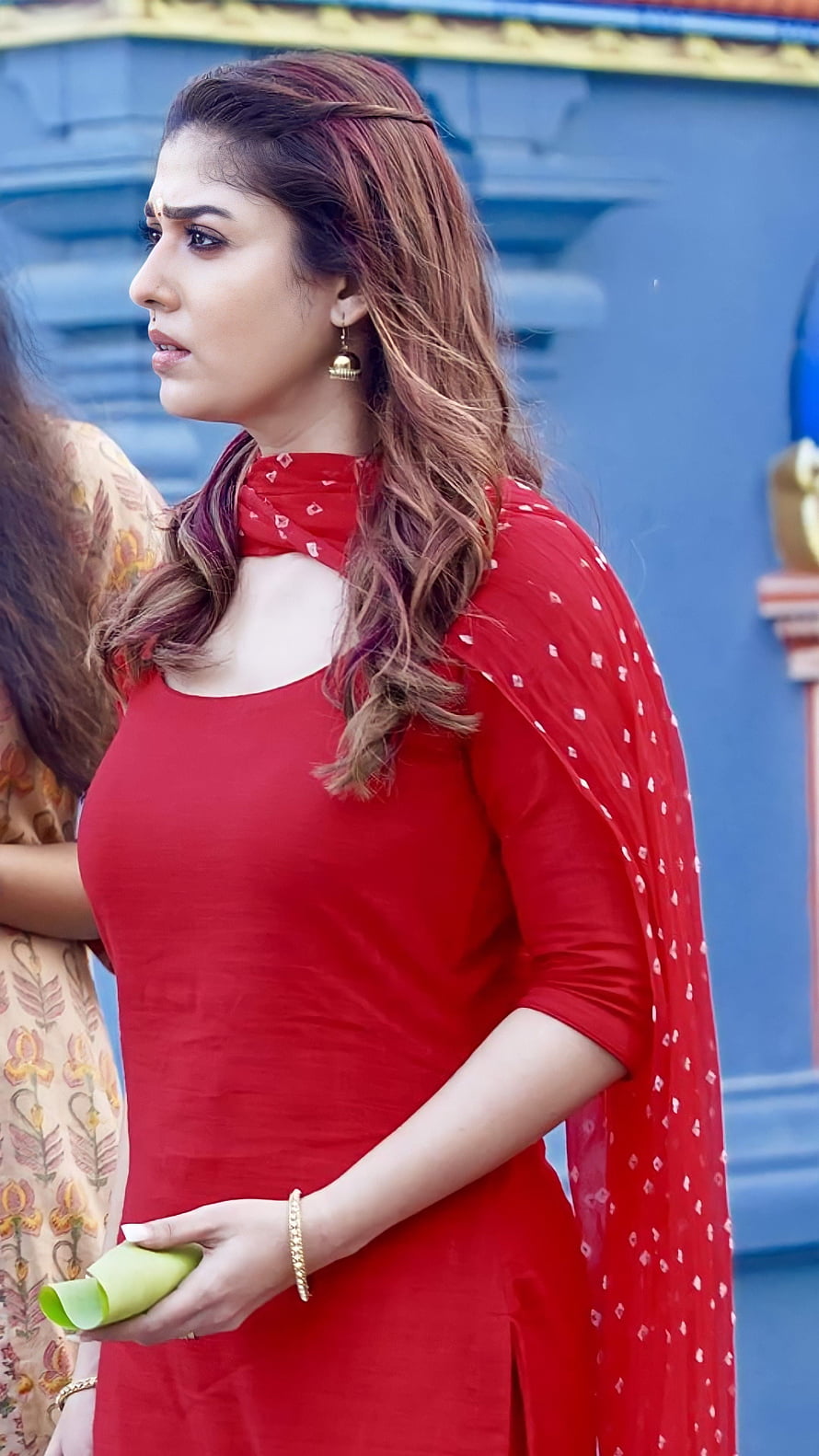 Nayantara in a red ethnic kurta with a matching dupatta against a blue architectural backdrop HD phone wallpaper