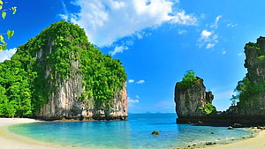 Tropical Lagoon with Lush Green Cliffs and Turquoise Water Under a Bright Blue Sky HD wallpaper