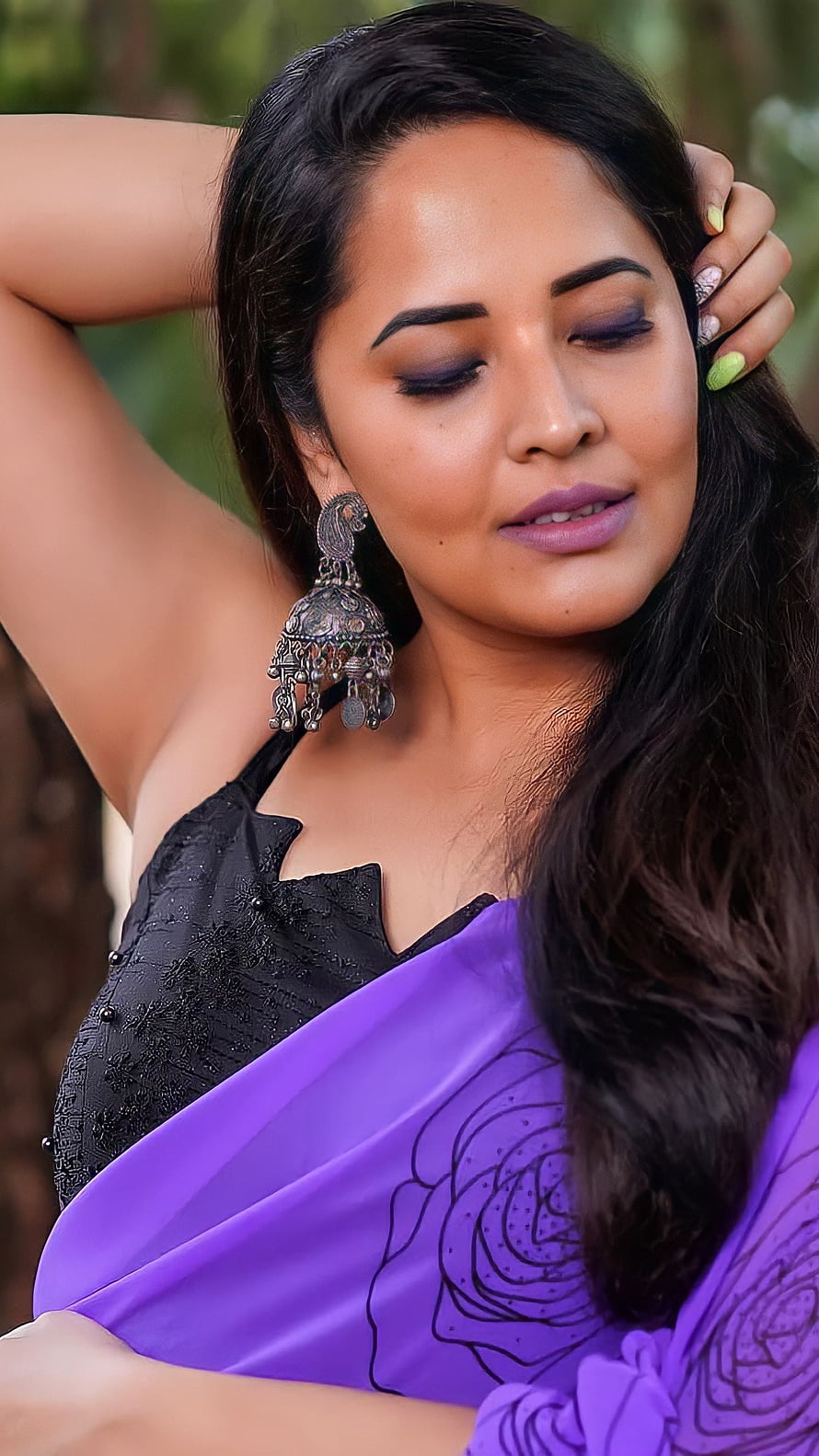 Anusuya Bharadwaj in a purple saree with traditional silver jhumka earrings and elegant makeup HD phone wallpaper