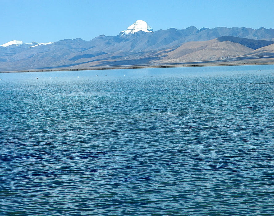 Mount Kailash Rising Above a Serene High-Altitude Lake Under a Clear Blue Sky HD wallpaper