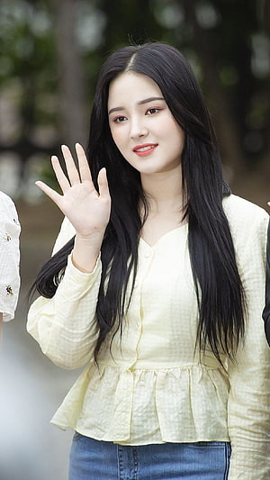 Nancy from Momoland Waving in a Pale Yellow Blouse and Denim HD phone wallpaper