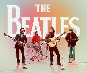The Beatles performing live with guitars and drums against a warm gradient backdrop HD wallpaper