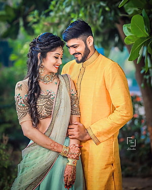 Indian Bridal Couple in Traditional Attire with Henna and Jewelry in Garden Setting HD phone wallpaper