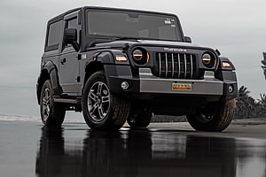 Black Mahindra Thar SUV Parked on Wet Asphalt with Coastal Background HD wallpaper