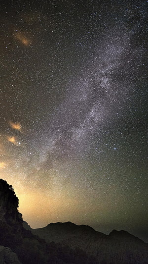 Milky Way Galaxy Arching Over Silhouetted Mountain Ridge in Mallorca, Spain HD phone wallpaper