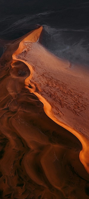 Aerial View of Dramatic Sand Dune Ridge with Golden Sunset Light and Deep Shadows HD phone wallpaper