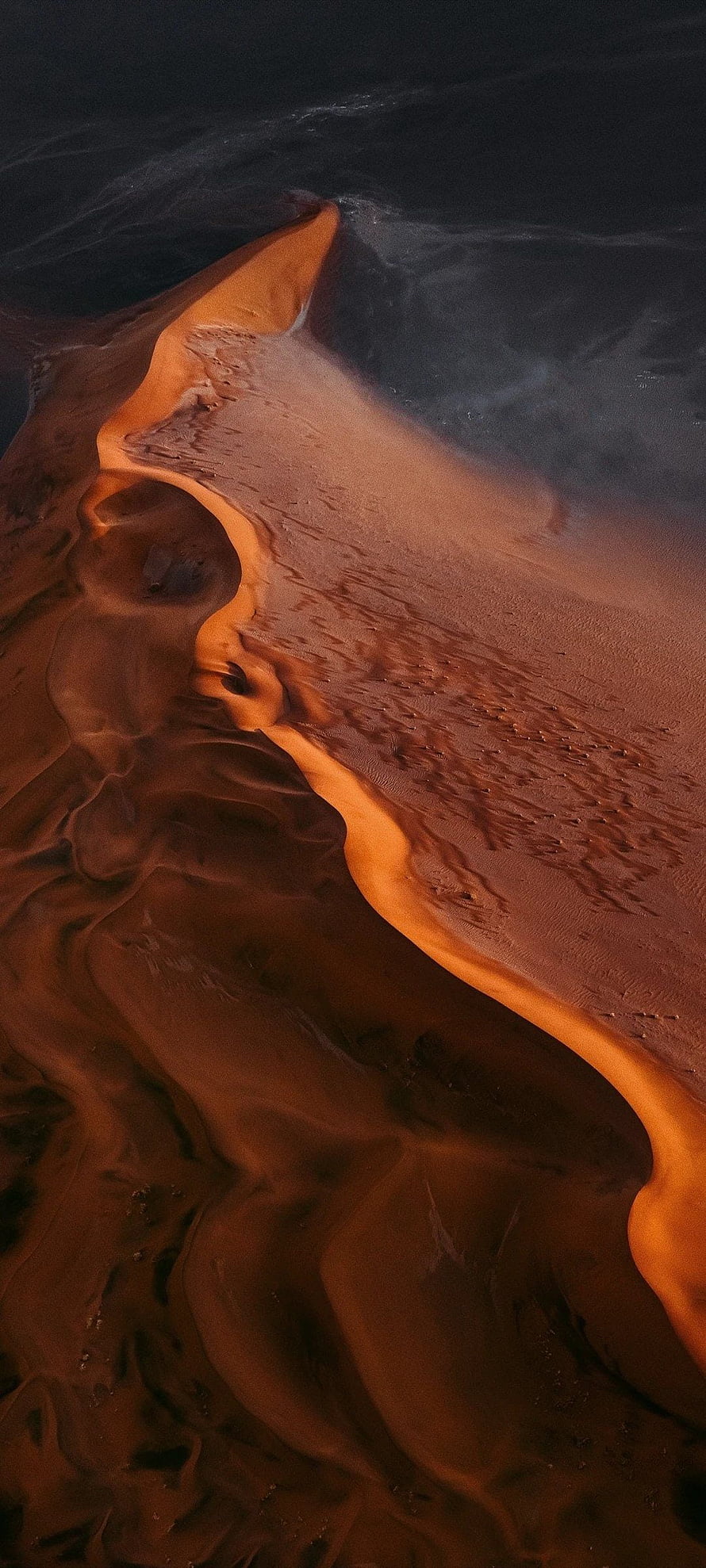 Aerial View of Dramatic Sand Dune Ridge with Golden Sunset Light and Deep Shadows HD phone wallpaper