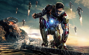 Iron Man landing on rocky terrain with multiple armored figures flying in the background HD wallpaper