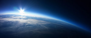 Sunrise Over Earth's Horizon From Orbit With Atmospheric Glow HD wallpaper