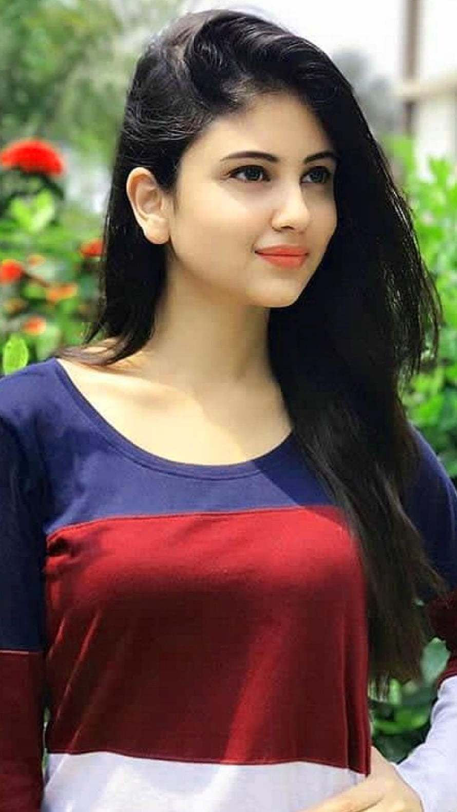 Portrait of a young woman with long dark hair wearing a color-block top in a garden setting, Indian Beautiful Cute Girls Close Up HD phone wallpaper
