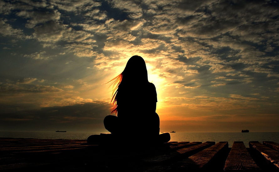 Silhouette of a Woman Meditating on a Pier at Sunset HD wallpaper