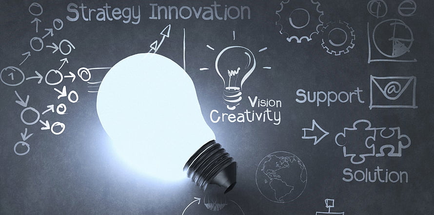 Glowing Light Bulb on Chalkboard with Business Strategy and Innovation Concepts HD wallpaper
