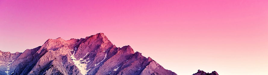 Purple Mountain Peaks Under a Vibrant Pink Sky at Sunset HD wallpaper