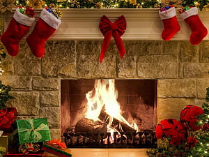 Cozy Christmas Fireplace With Stockings, Poinsettias, and Wrapped Gifts HD wallpaper