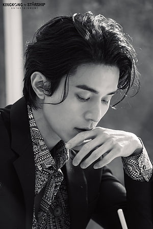 Lee Dongwook in a moody black and white portrait wearing a patterned shirt and dark blazer HD phone wallpaper