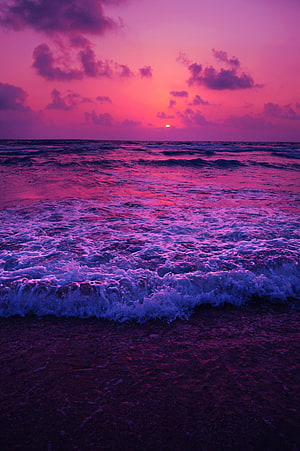 Vibrant Purple Ocean Sunset with Foaming Waves and Dramatic Clouds HD phone wallpaper
