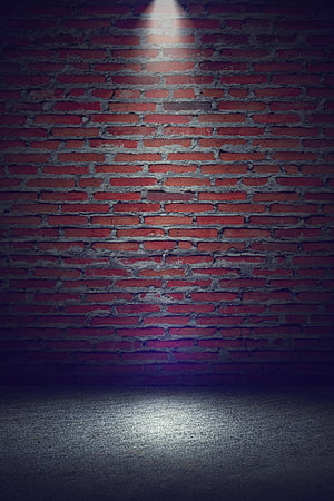 Moody Red Brick Wall with Dramatic Spotlight and Concrete Floor HD phone wallpaper