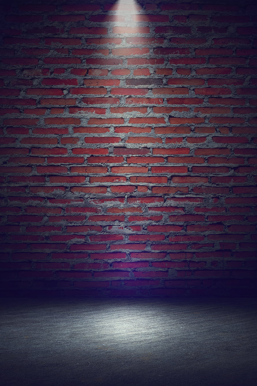 Moody Red Brick Wall with Dramatic Spotlight and Concrete Floor HD phone wallpaper