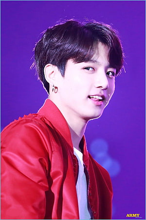 BTS Jungkook in a red satin bomber jacket against a purple stage backdrop HD phone wallpaper