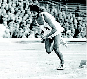 Milkha Singh Sprinting on the Track in a Vintage Black and White Photograph HD wallpaper