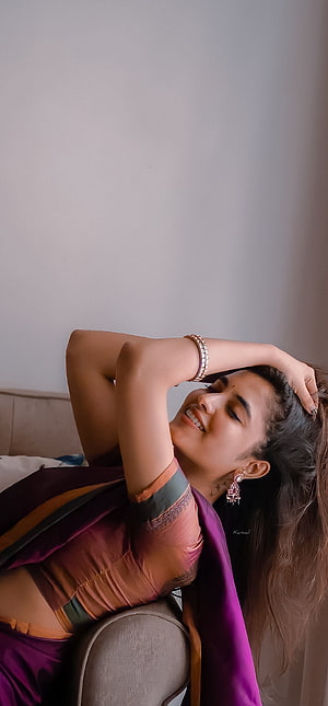 Priyanka Arul Mohan in a purple and orange saree with traditional jewelry HD phone wallpaper