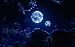 Two Glowing Moons Illuminating a Dark Night Sky with Wispy Clouds HD wallpaper
