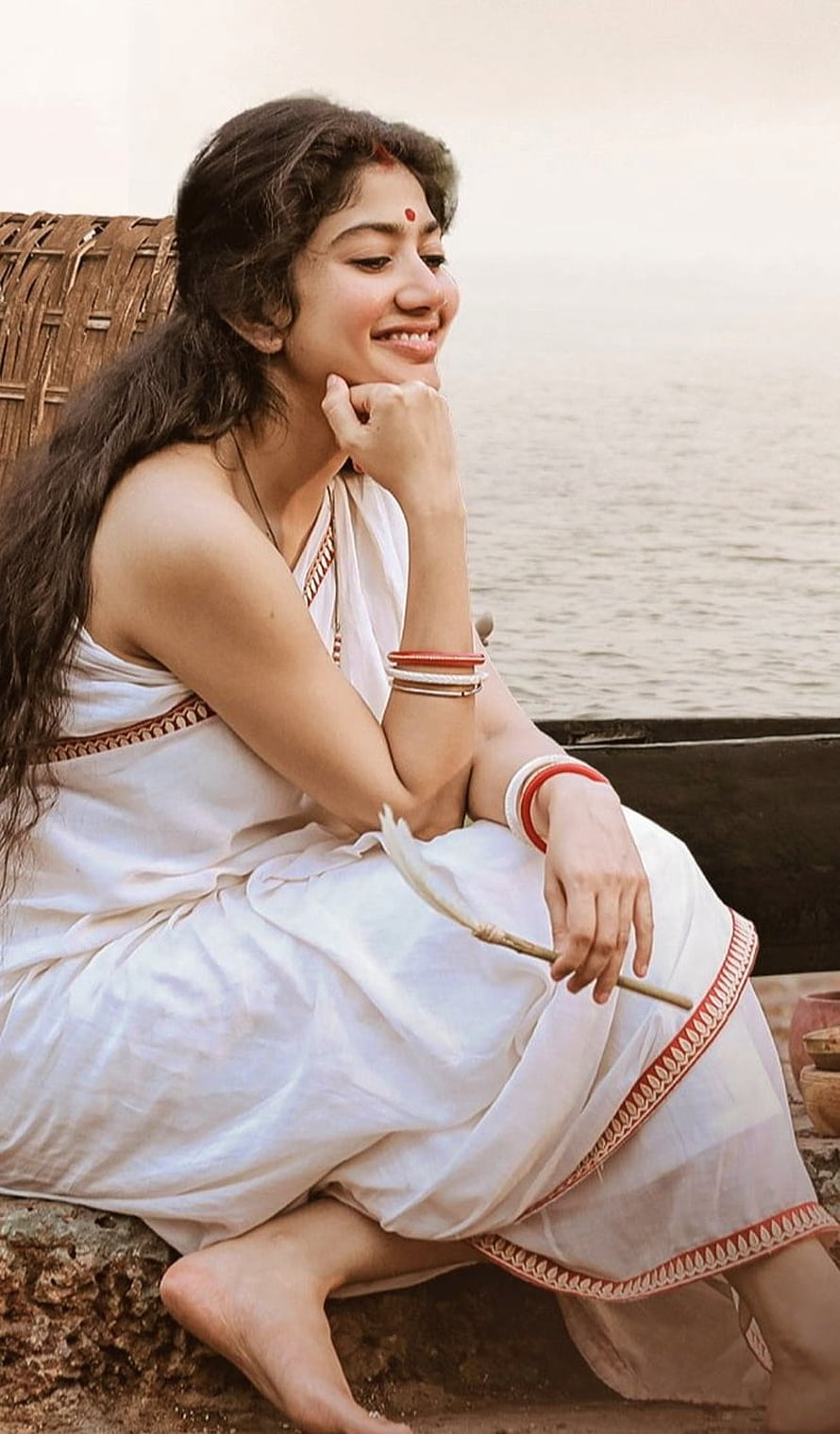 Sai Pallavi in Traditional White Saree Sitting by the Water HD phone wallpaper