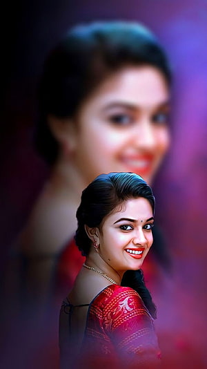 Keerthi Suresh in a red patterned blouse with a soft-focus portrait background HD phone wallpaper