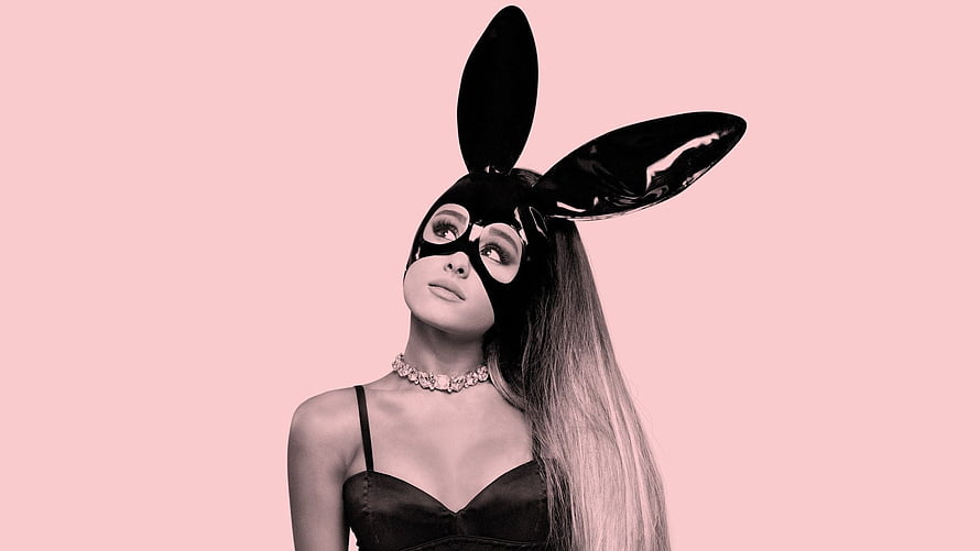 Ariana Grande in a black bunny mask and satin top against a soft pink background HD wallpaper