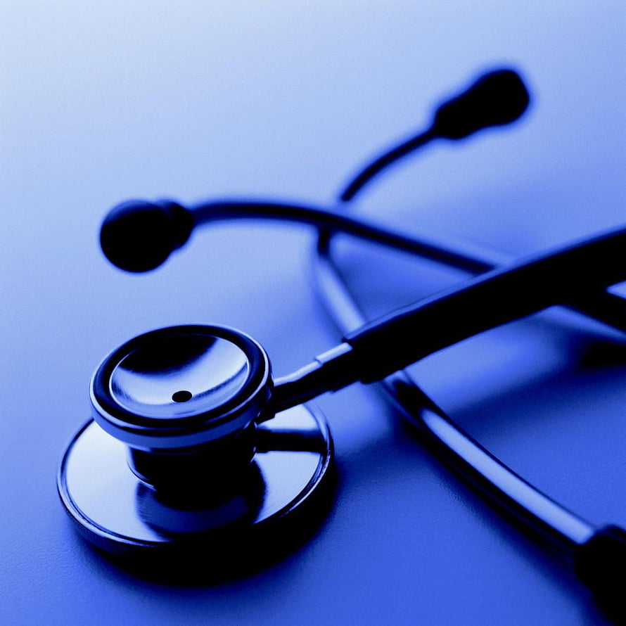 Close-up of a stethoscope on a blue surface with a shallow depth of field HD phone wallpaper