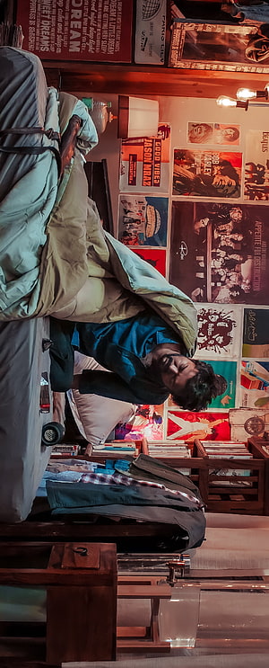Vijay Thalapathy in a Cozy Bedroom with Vintage Music Posters and Warm Ambient Lighting HD phone wallpaper