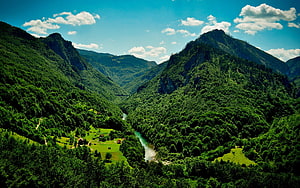 Lush Green Mountain Valley With Winding River And Scattered Cottages Under Blue Sky HD wallpaper