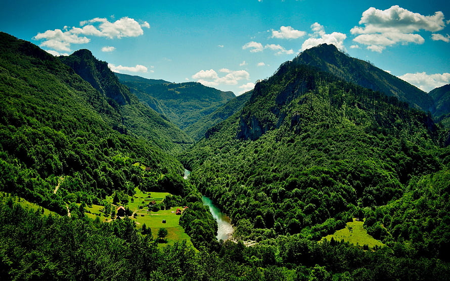 Lush Green Mountain Valley With Winding River And Scattered Cottages Under Blue Sky HD wallpaper
